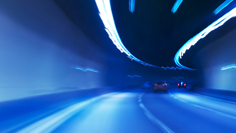 Blurred cars driving quickly through a tunnel
