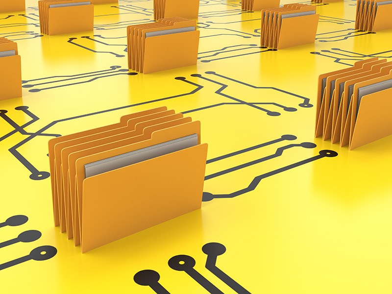 Yellow files on top of a yellow table with black lines on it